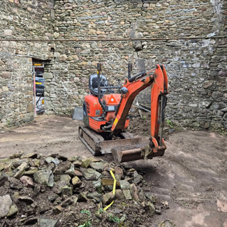 excavator machine in stone building with pile of rocks for construction project