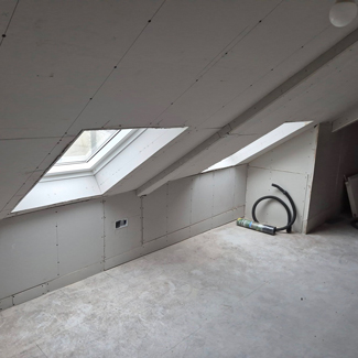 unfinished attic room with sloped walls and skylights featuring tools for renovation and modern interior design tips for ten improvements
