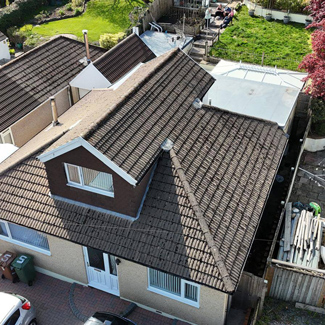 aerial view of a residential house with a brown tiled roof and garden nearby showcasing property features ideal for 16 home buyers