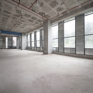 empty modern interior with large windows and concrete walls suitable for five office spaces or creative studios