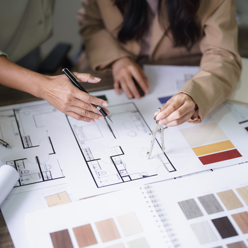 two hands discussing architectural plans with design color samples nearby focusing on interior design and space planning 3D visualization