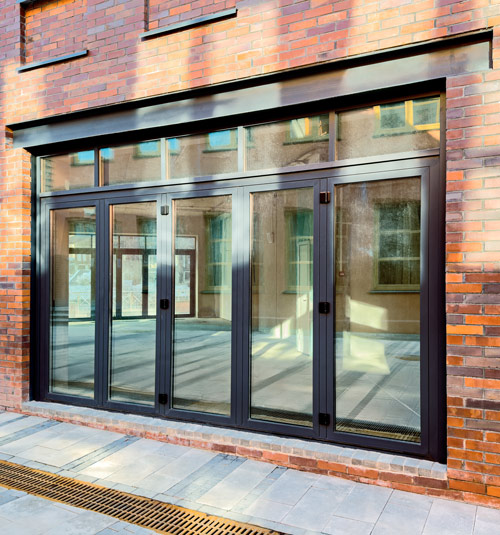 modern glass sliding doors in a brick wall featuring three panels and a sleek design