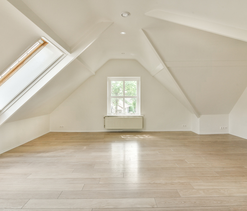 spacious empty room with slanted ceiling and skylight bright natural light flooring ideal for design renovation 1