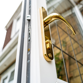 close up of a modern door handle with gold finish showcasing security features and design elegance suitable for 17 home styles